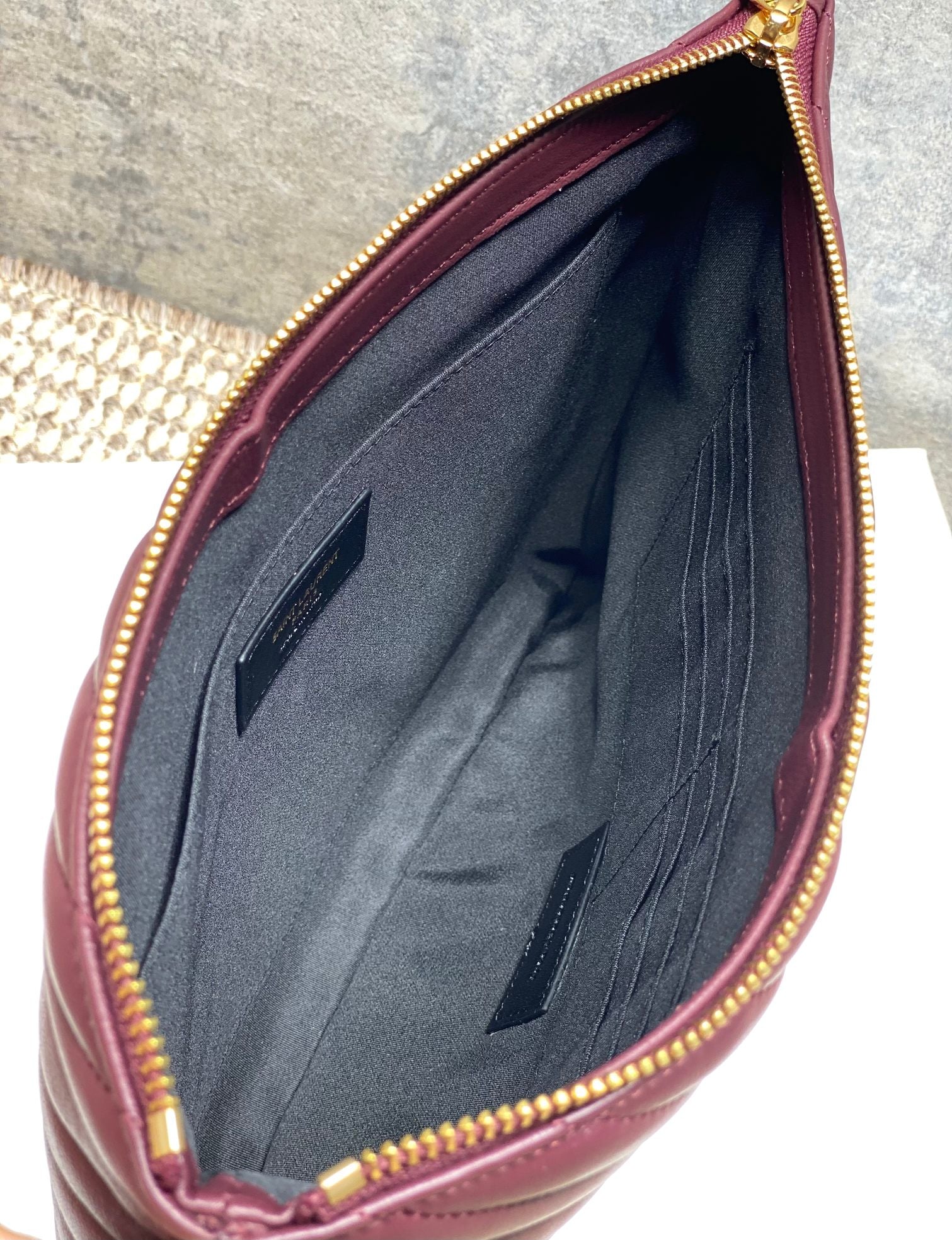 Open burgundy small bag interior with gray lining and inner pocket
