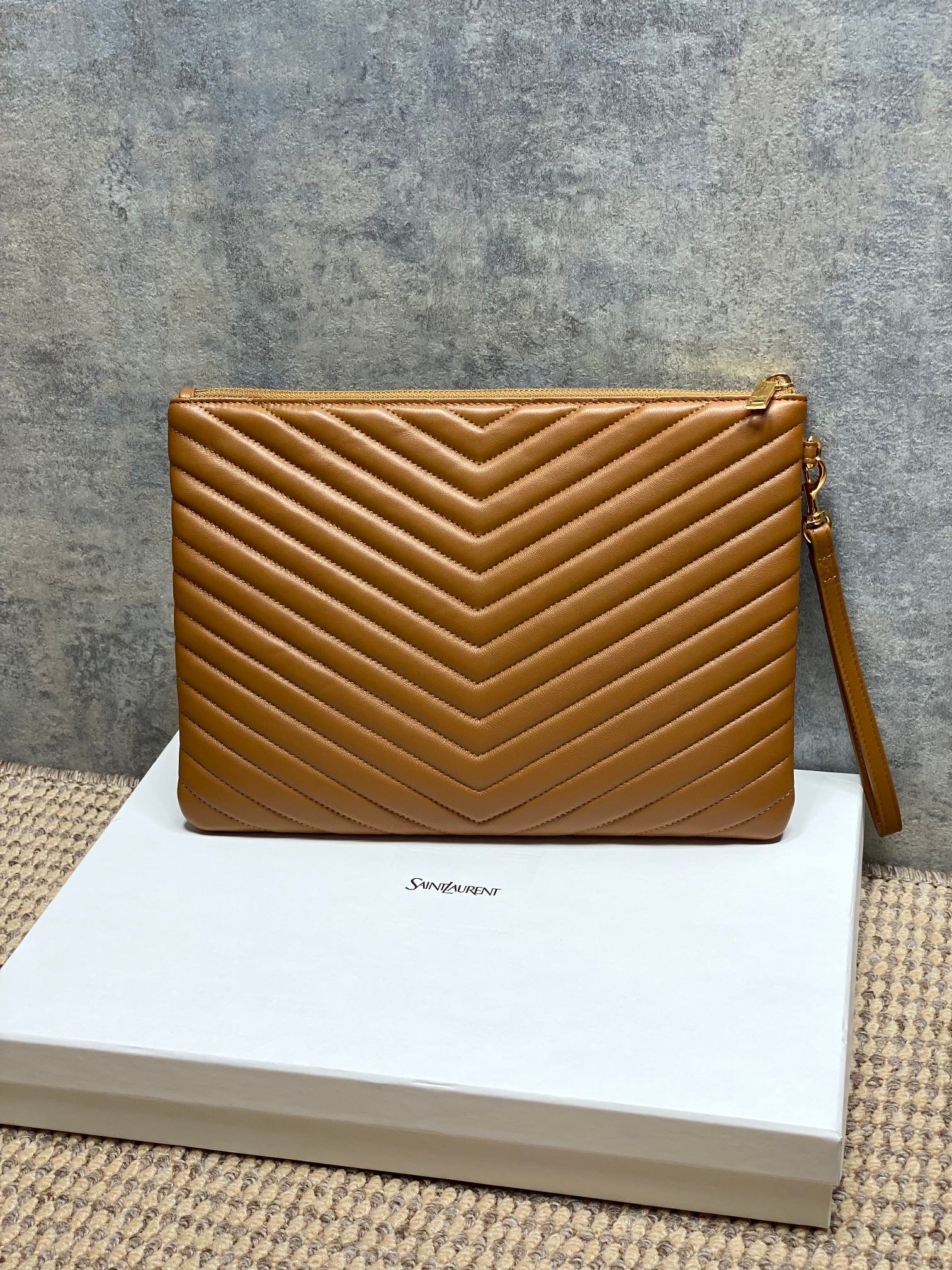 YSL quilted pouch bag with chevron stitching, tan leather, wrist strap, zip closure