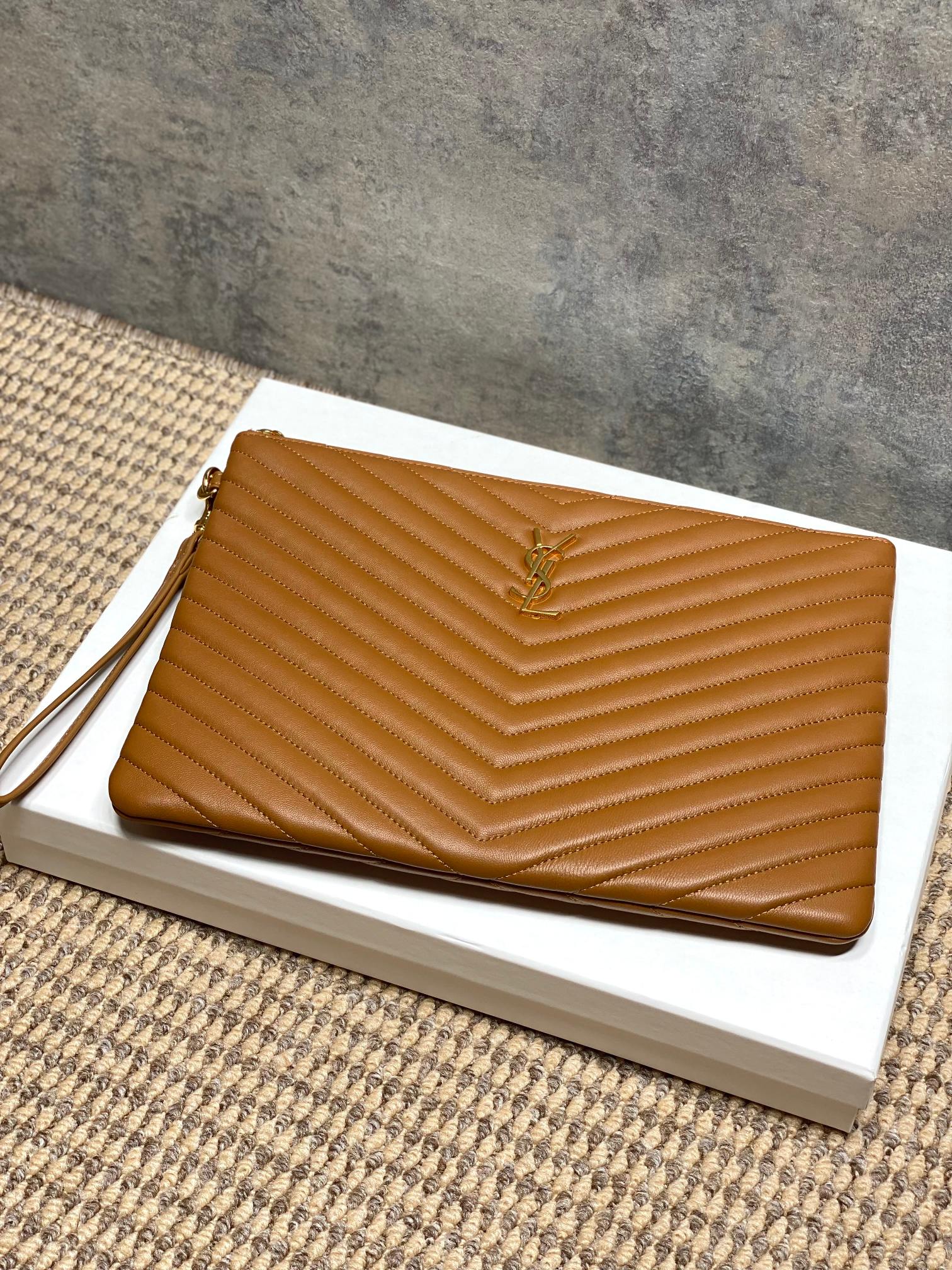 YSL tan quilted clutch bag with chevron ridges and gold-tone zipper