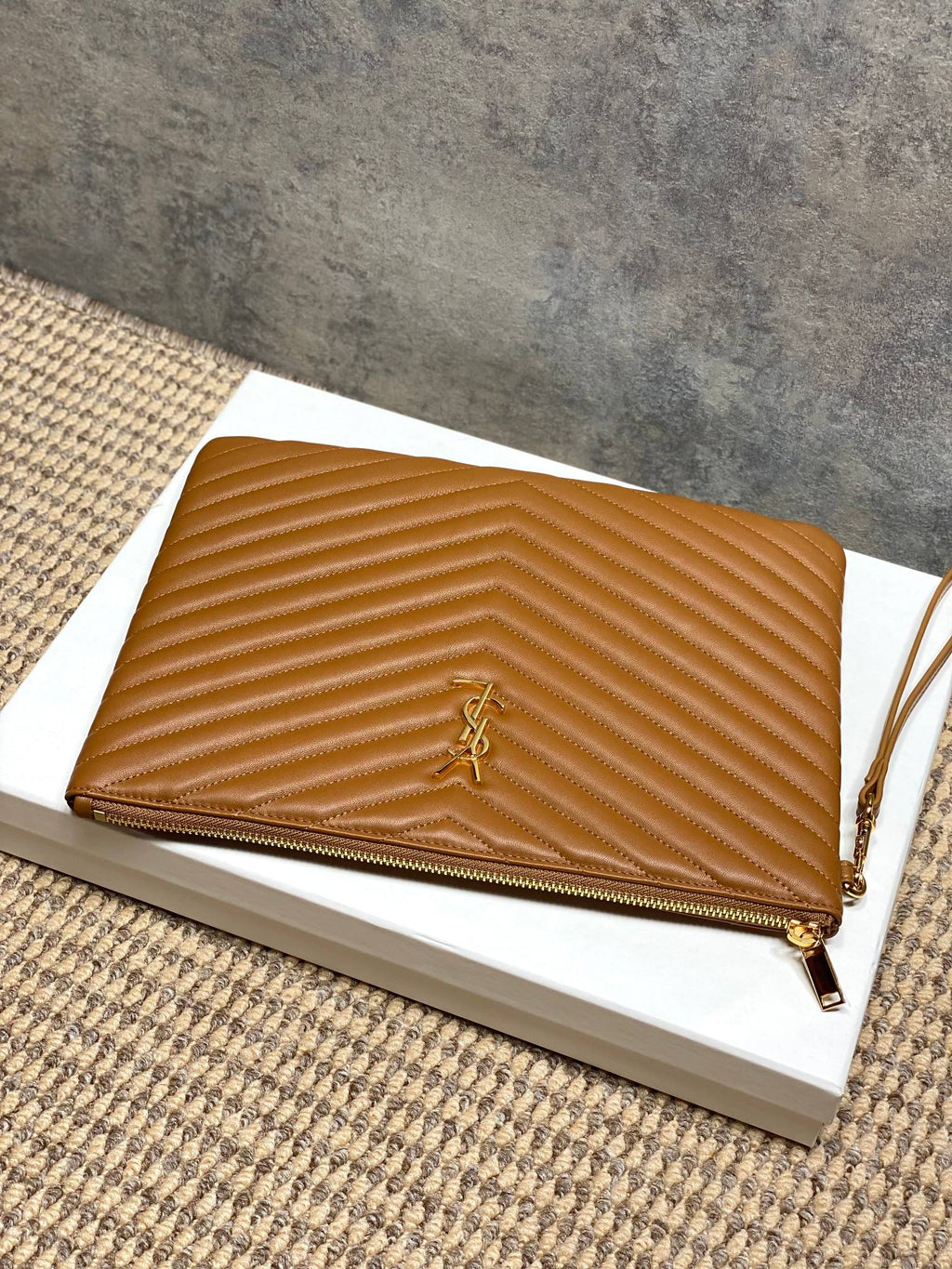 YSL tan quilted crossbody bag with chevron texture, gold YSL logo and zip closure