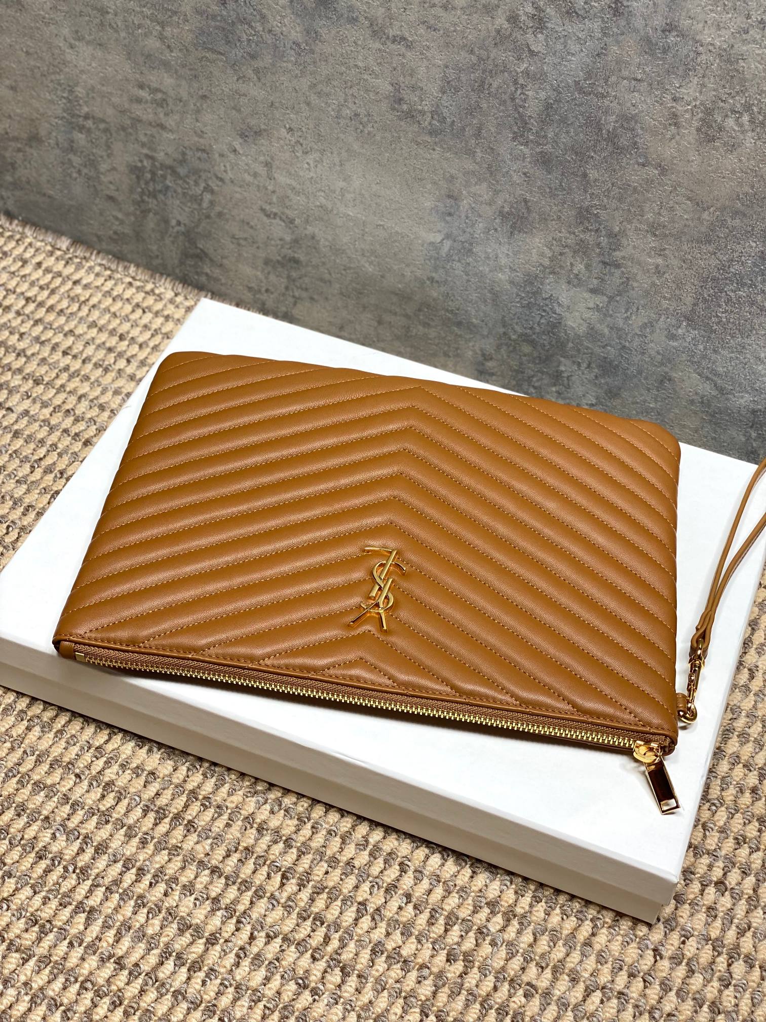 YSL tan quilted crossbody bag with chevron texture, gold YSL logo and zip closure
