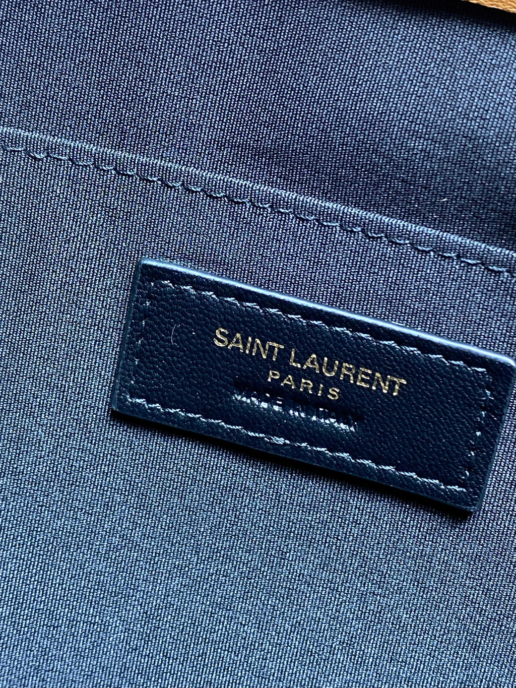 Saint Laurent Paris label on navy fabric lining inside YSL small bag