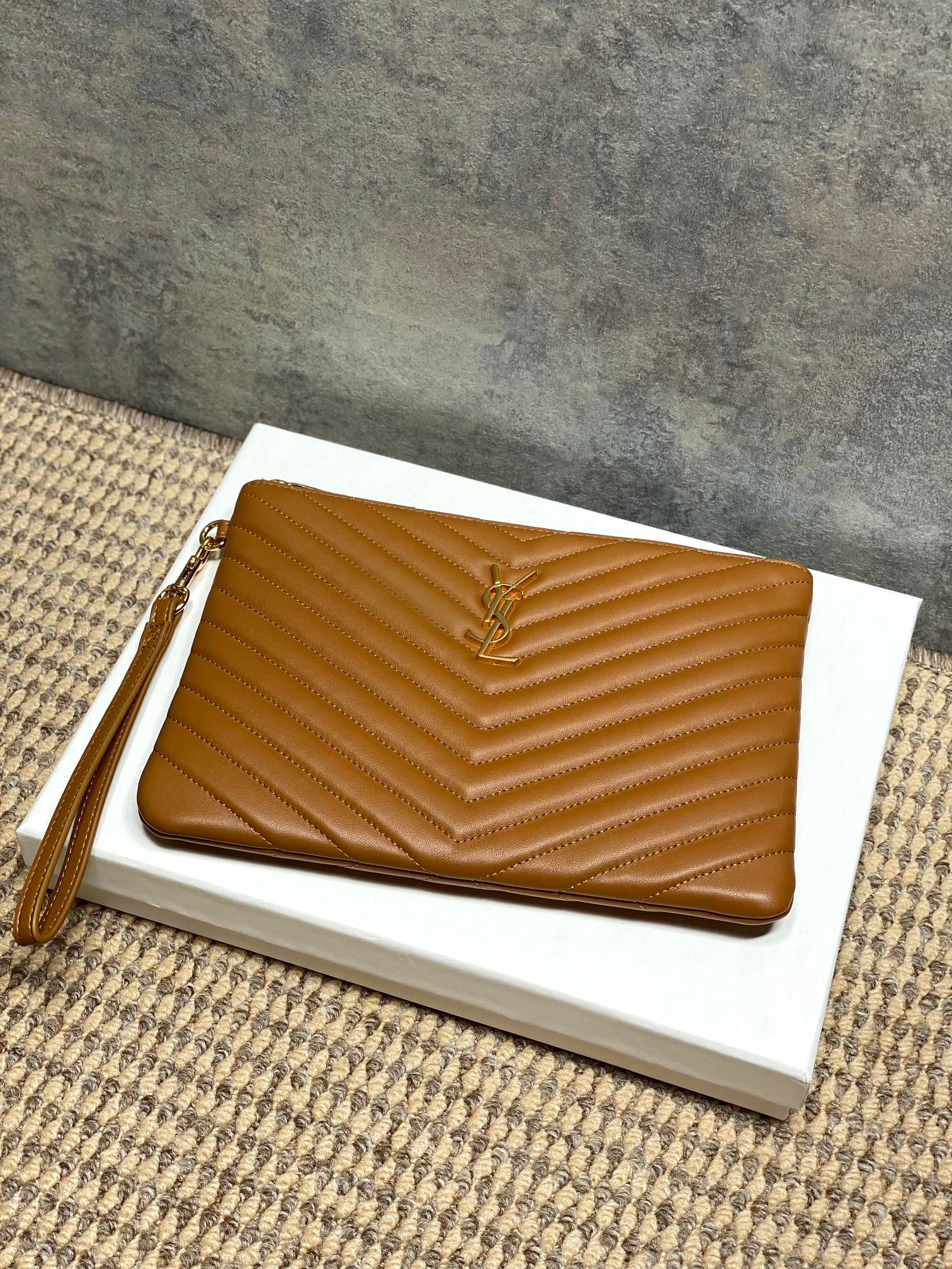 Small YSL quilted bag with chevron pattern, wrist strap, brown leather