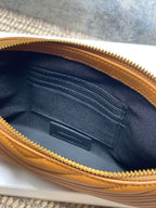 Small bag interior with navy lining, card slots, and gold zipper trim, brown