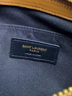 Navy interior label reading SAINT LAURENT PARIS on small bag