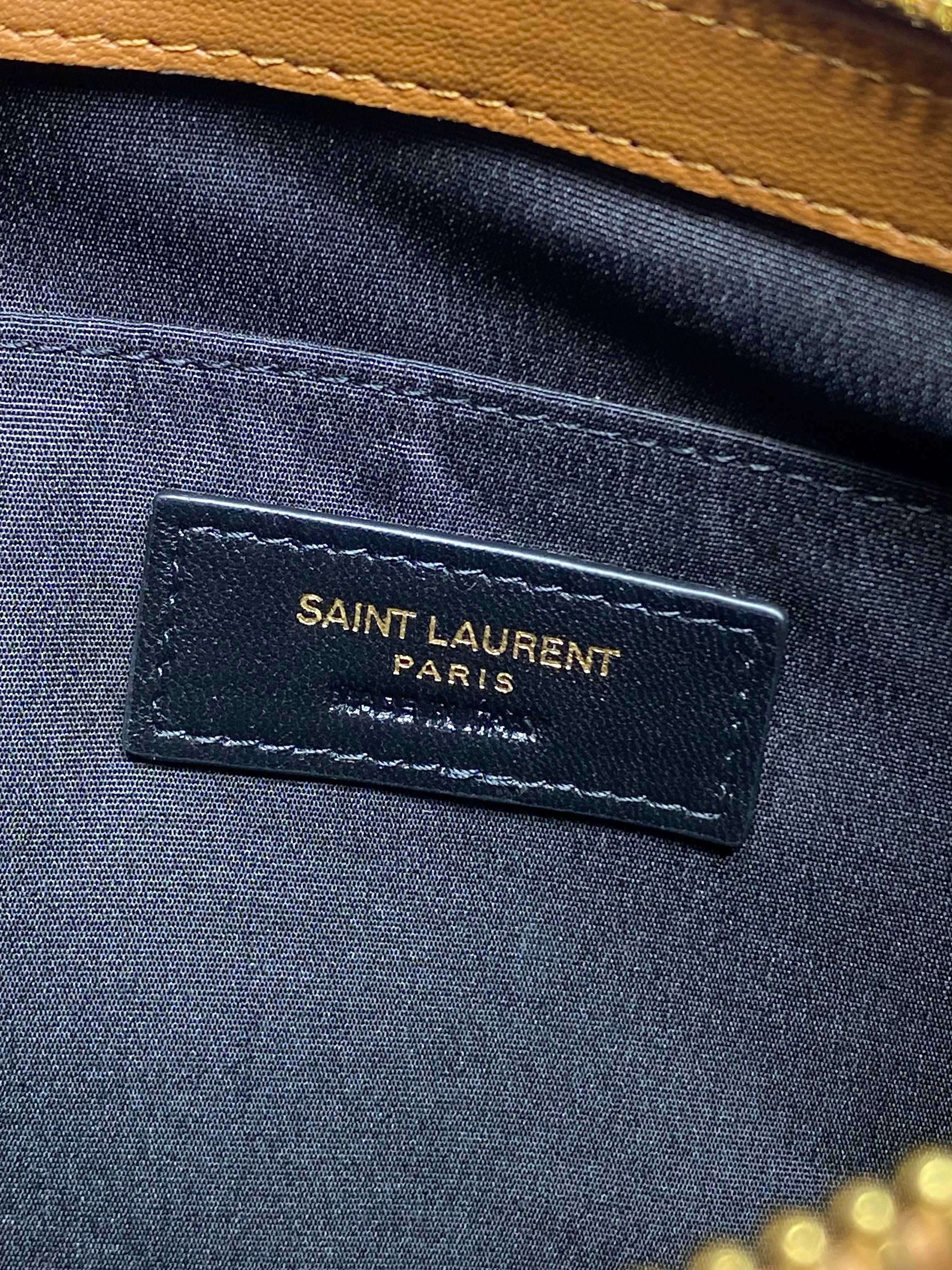 Navy interior label reading SAINT LAURENT PARIS on small bag
