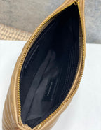 YSL small bag interior with dark lining and curved opening with gold zipper trim