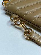 YSL quilted bag strap detail with gold chain hardware and clip on tan leather