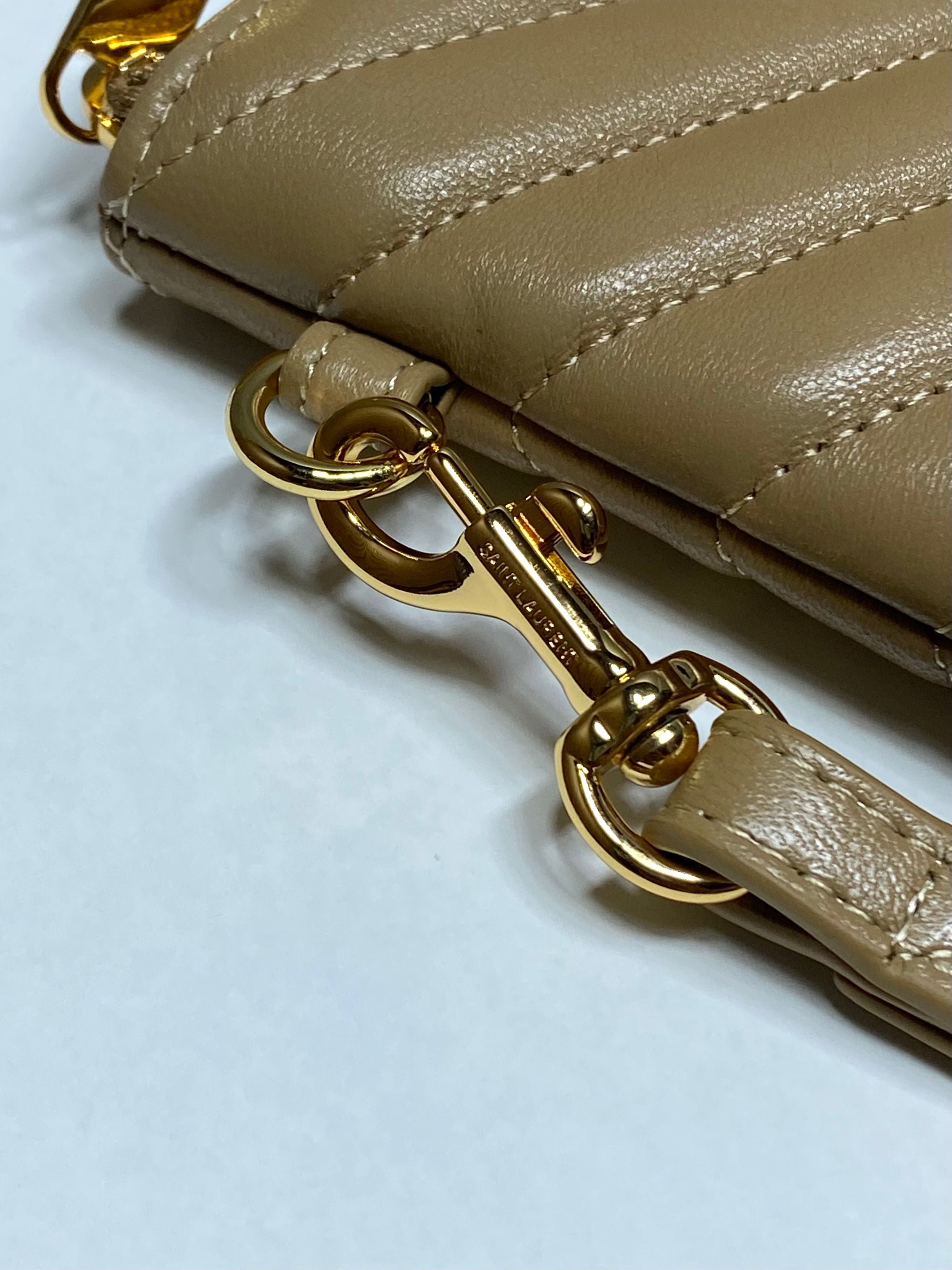 YSL quilted bag strap detail with gold chain hardware and clip on tan leather