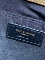 YSL Saint Laurent Paris logo patch on dark fabric lining inside the bag