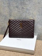 Small YSL quilted shoulder bag in dark burgundy with gold YSL logo and top zipper.