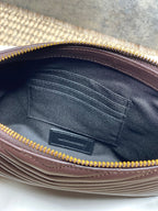 Small YSL bag interior view with stitched lining and gold-tone zipper opening.