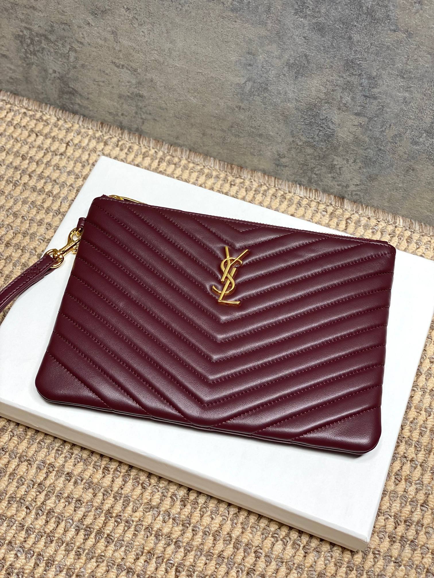 Burgundy quilted small clutch bag with front YSL logo and gold chain