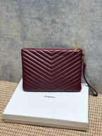 Burgundy quilted zip shoulder bag with gold-tone hardware and leather wrist strap