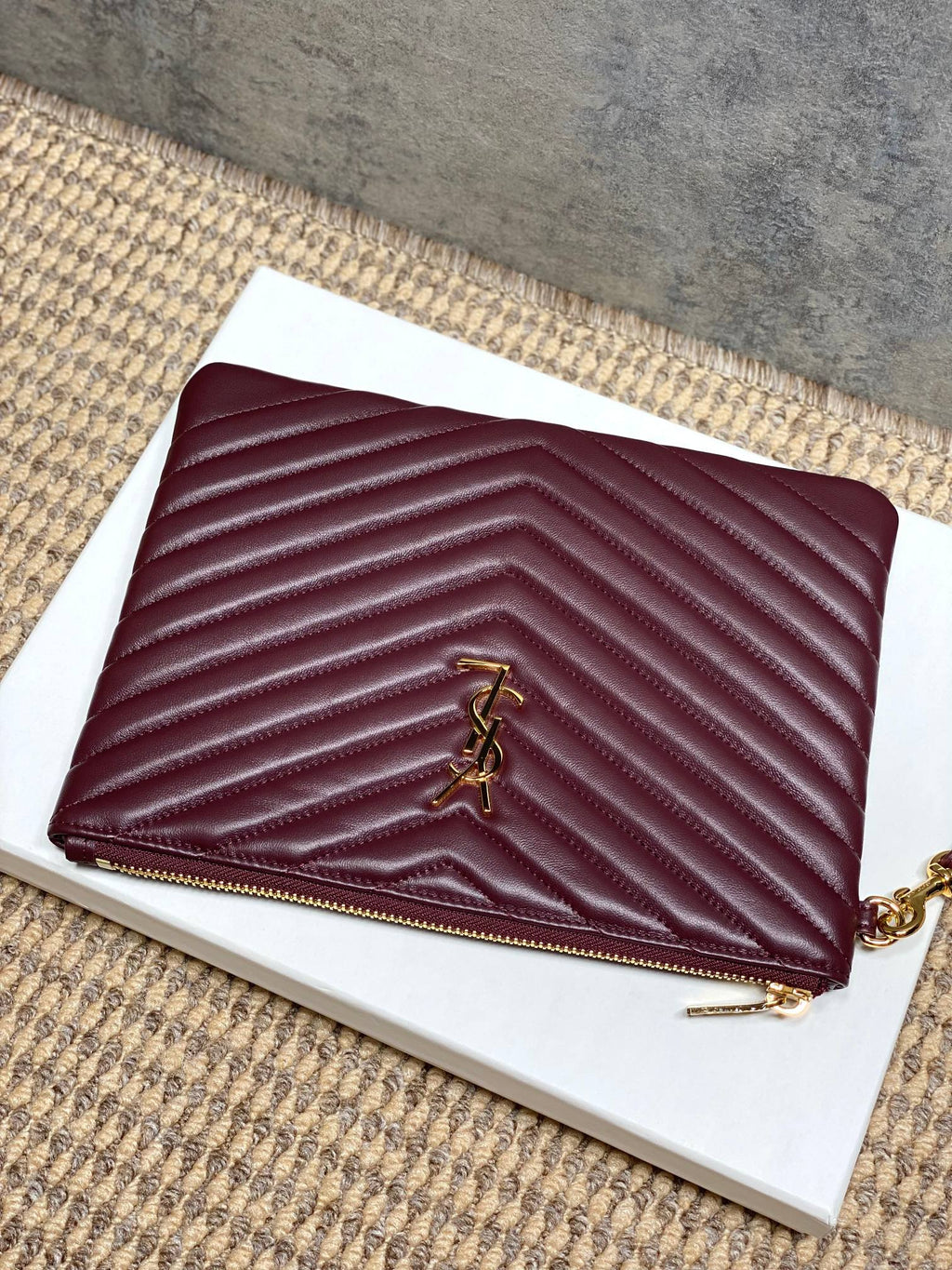 Burgundy quilted small clutch bag with YSL logo and top zipper