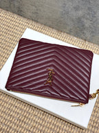 Burgundy quilted zip clutch bag with gold-tone logo detail and chain zipper pull