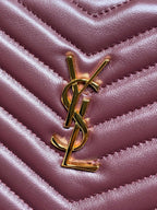 Gold-tone YSL-style logo emblem on burgundy quilted bag front