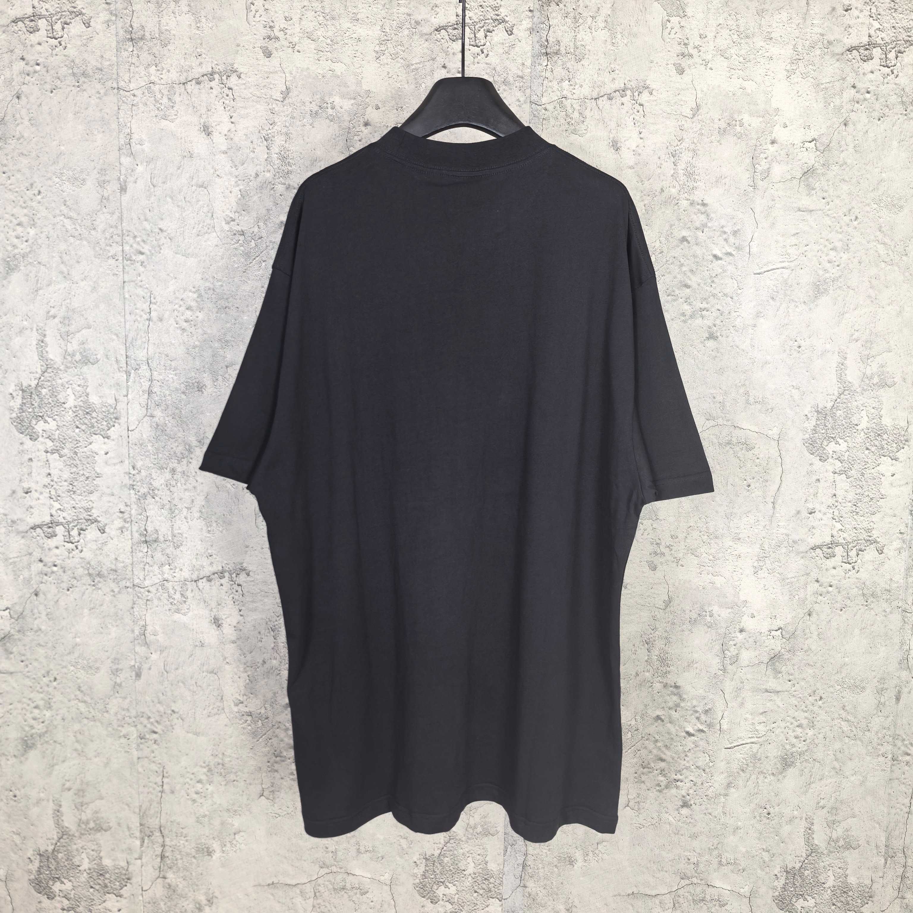 Balenciaga short-sleeve T-shirt, dark; plain back view on hanging display