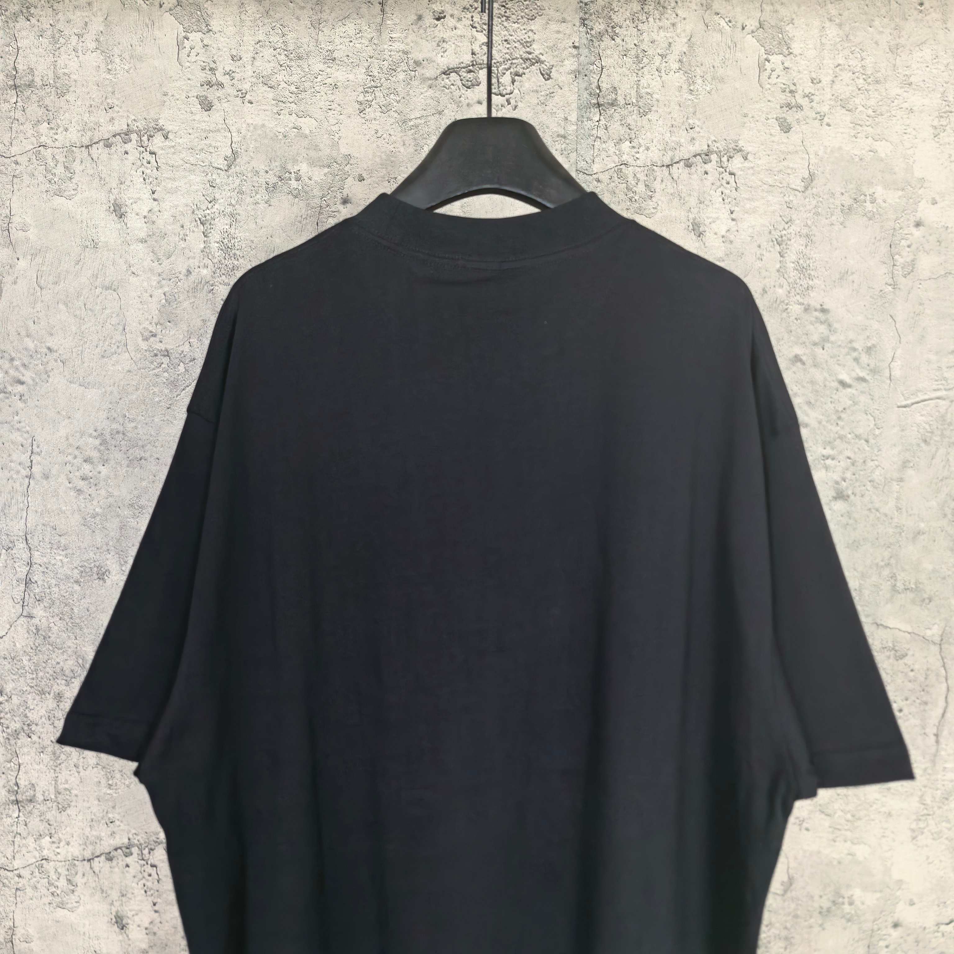 Balenciaga short-sleeve T-shirt, dark; plain back view with drape on hanger
