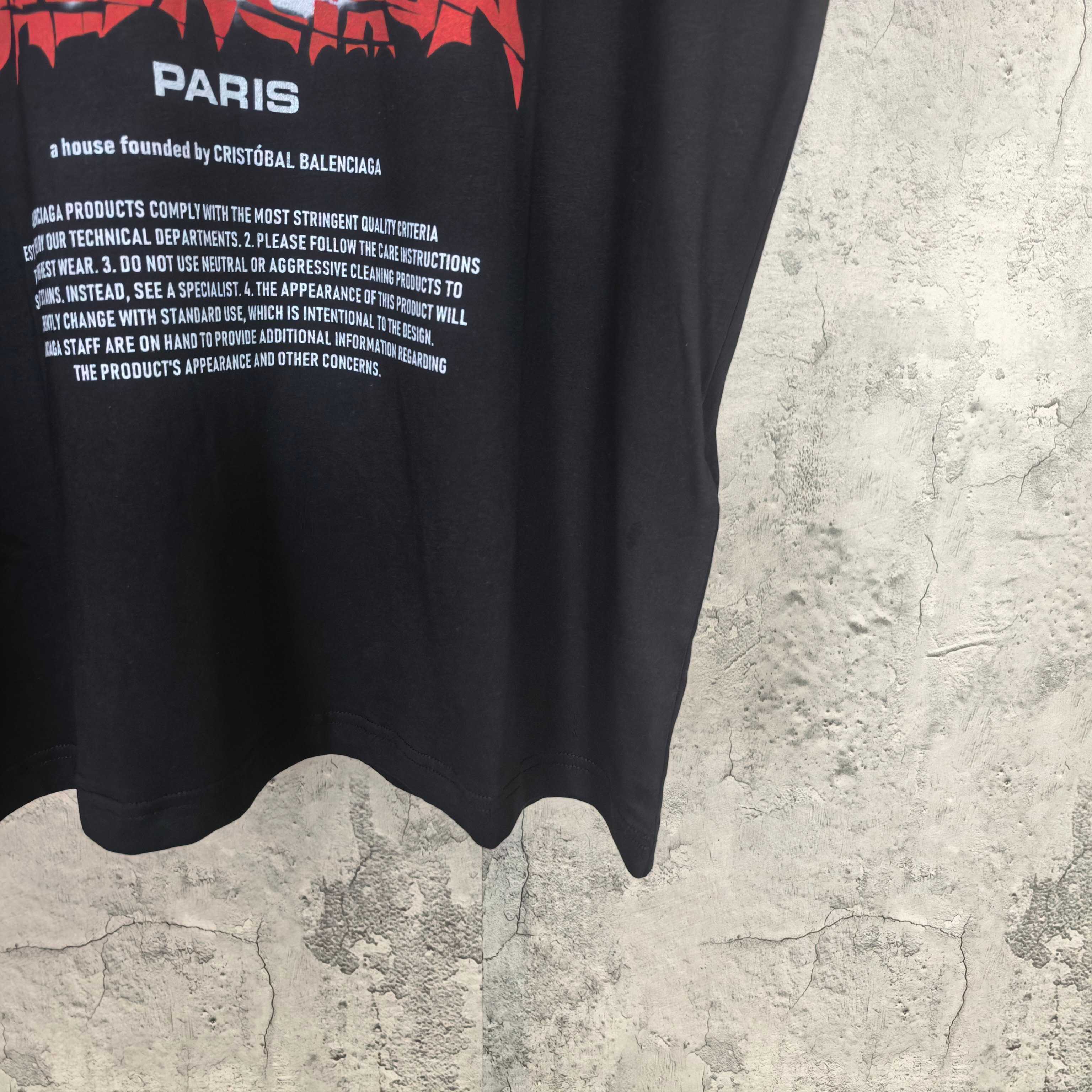 Balenciaga black graphic shirt with "PARIS" text and curved hem