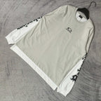 Off-white long T-shirt with crew neck and black graphic branding along sleeves