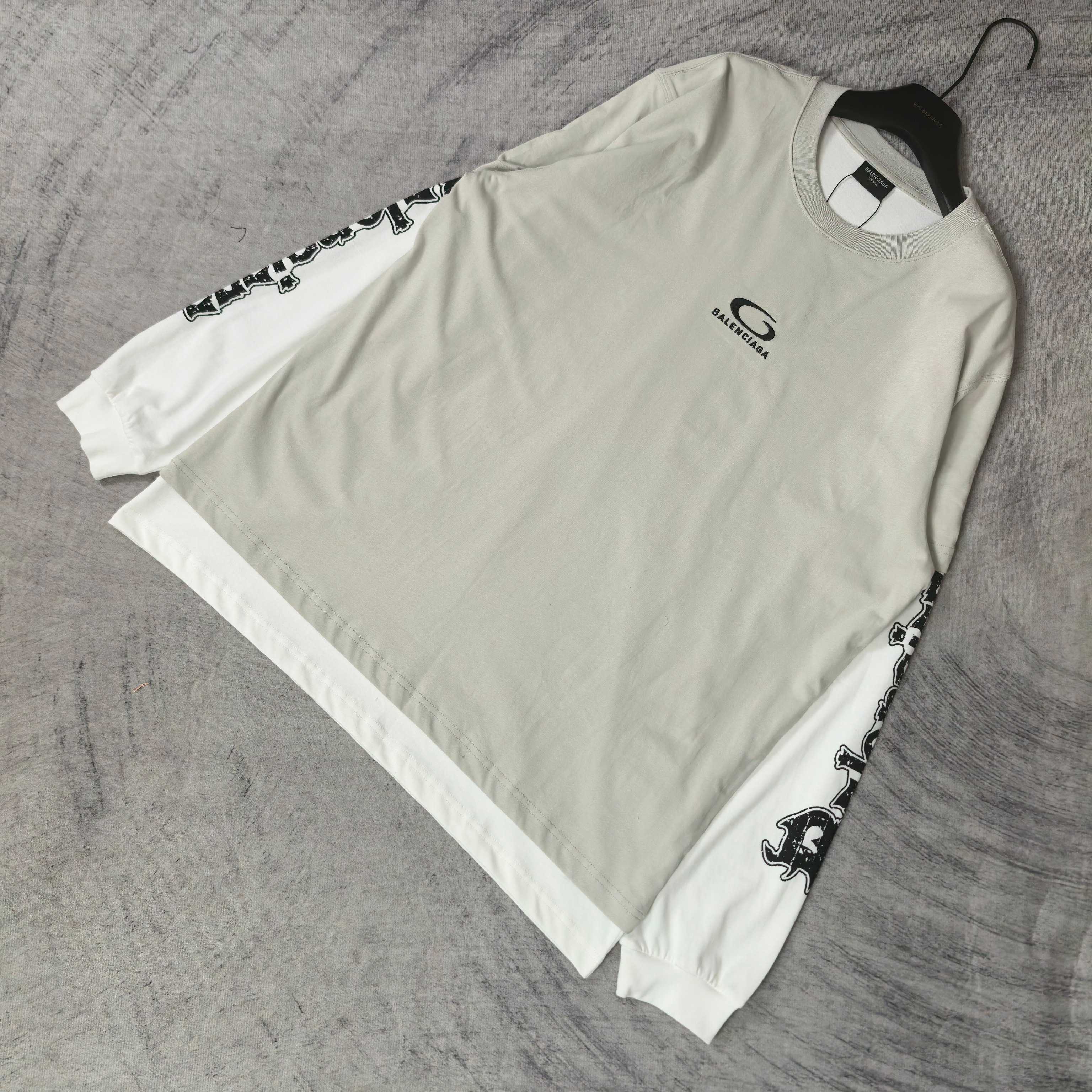 Off-white long T-shirt with crew neck and black graphic branding along sleeves