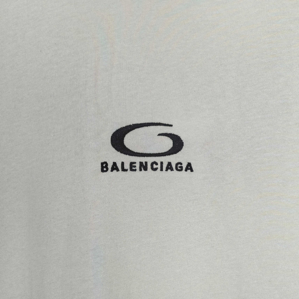 Chest logo on off-white long T-shirt reading BALENCIAGA