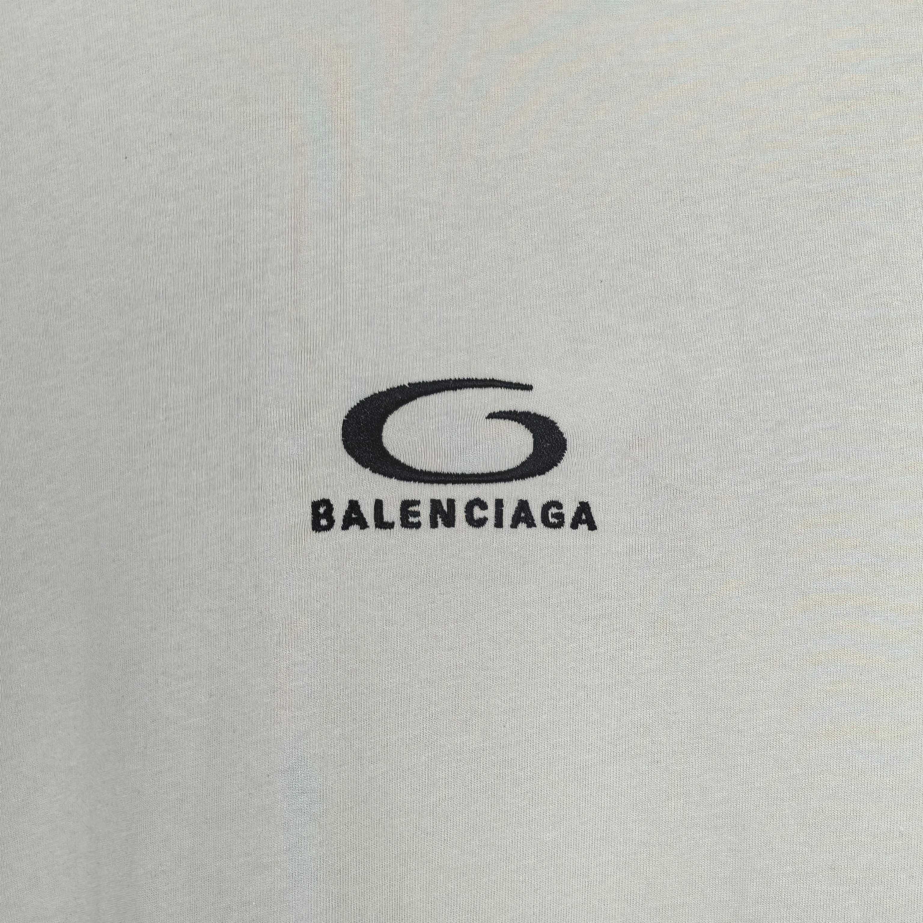 Chest logo on off-white long T-shirt reading BALENCIAGA