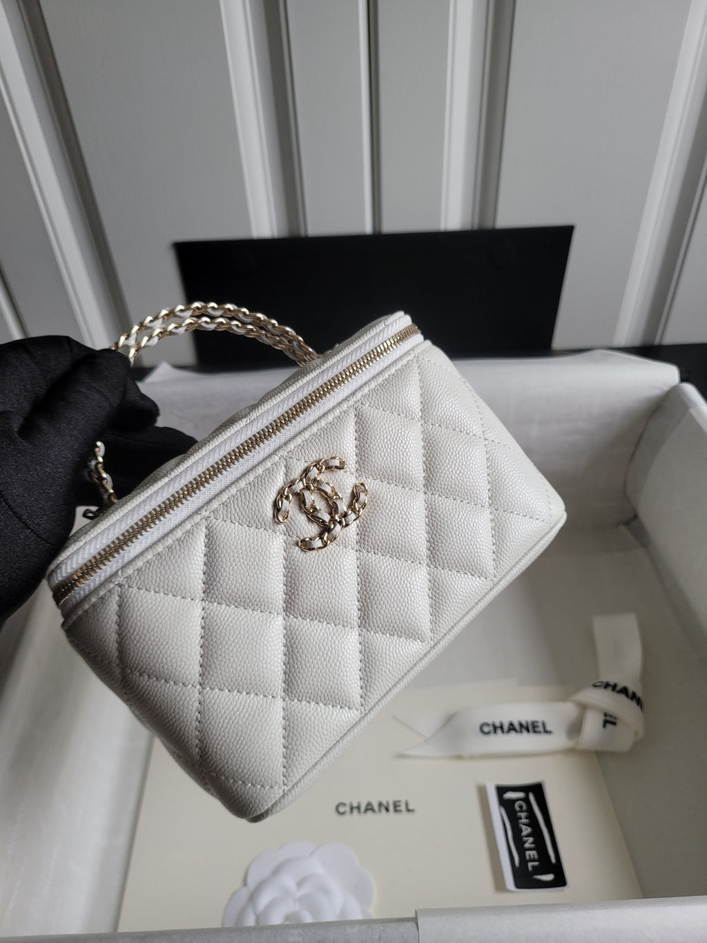Chanel bag, white quilted leather with gold chain strap and top zip front