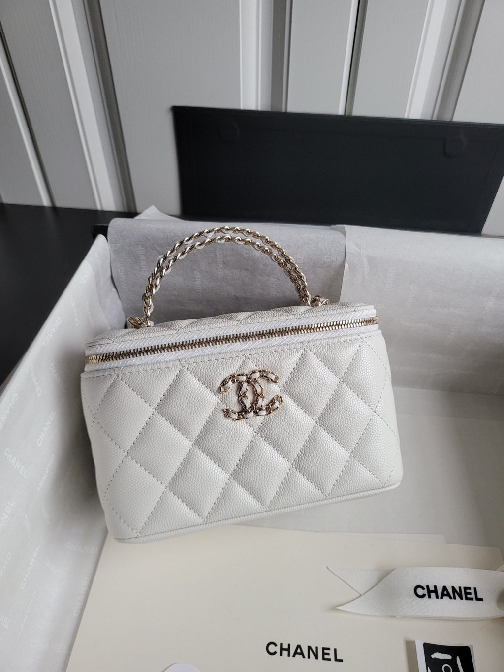 Chanel bag, white quilted leather with gold chain strap and top zip front