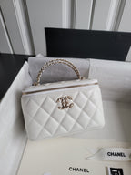 Chanel bag, white quilted leather with gold chain strap and top zip front