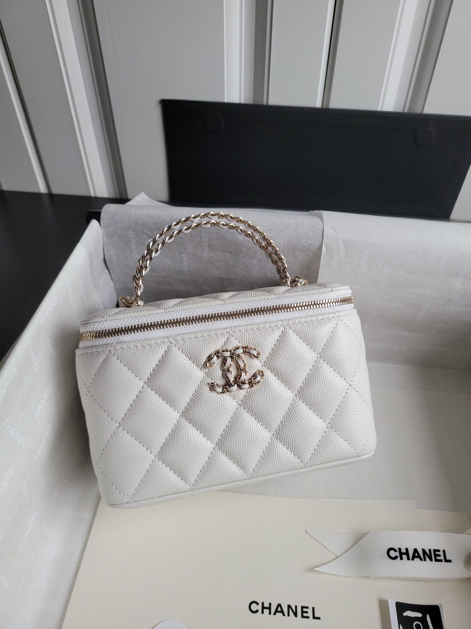 Chanel bag, white quilted leather with gold chain strap and top zip front