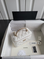 Chanel bag, white quilted leather with gold chain strap and top zip closure