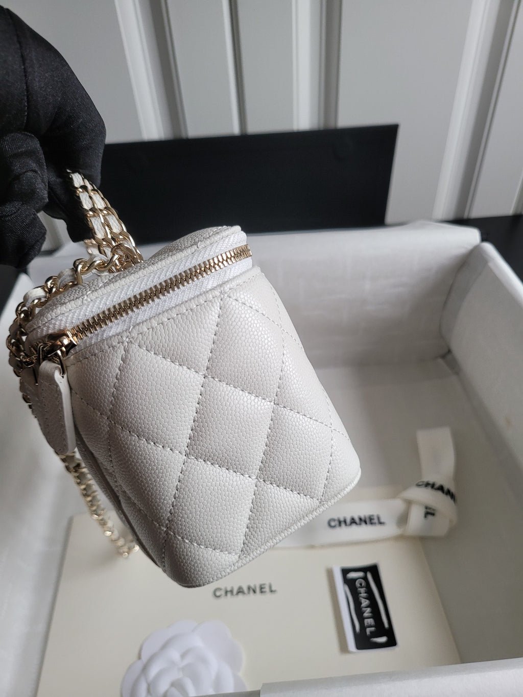 Chanel white quilted crossbody bag with chain strap and zip top, front view