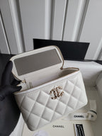 Chanel white quilted crossbody bag held open, showing interior and chain strap