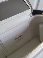 Chanel white quilted bag interior with card slots and zippered phone pocket