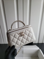 Chanel white quilted mini bag side view with chain handle and zip top