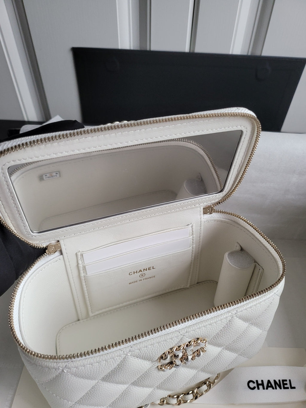 Chanel white quilted bag open with card slot pocket and gold-tone chain strap