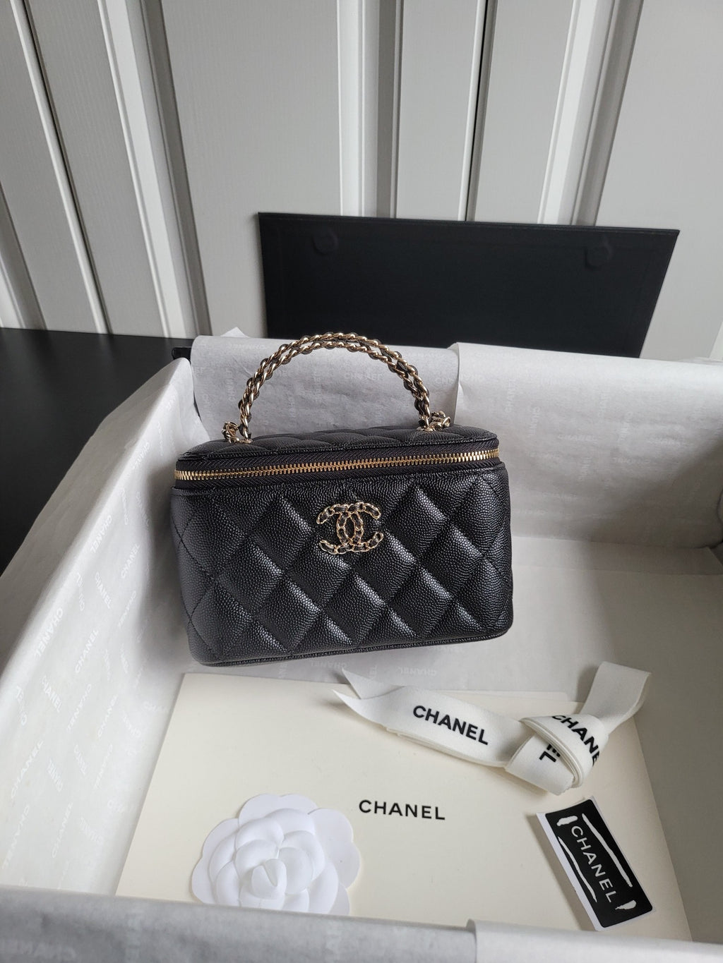 Chanel quilted mini handbag in dark color with chain top handle and front logo