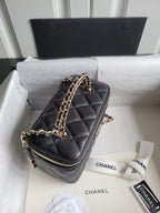 Chanel quilted mini handbag in dark color with long chain strap and front zip