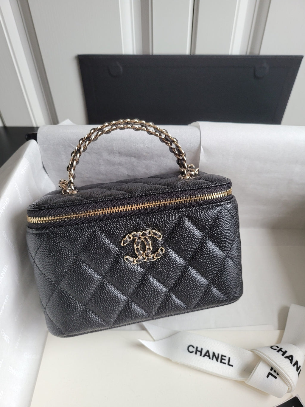 Chanel quilted mini handbag in dark color with gold-tone zip and chain handle