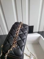 Chanel quilted mini handbag in dark color with chain strap and gold-tone zipper detail