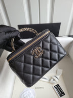 Chanel quilted mini handbag in dark color with gold-tone CC logo and chain strap