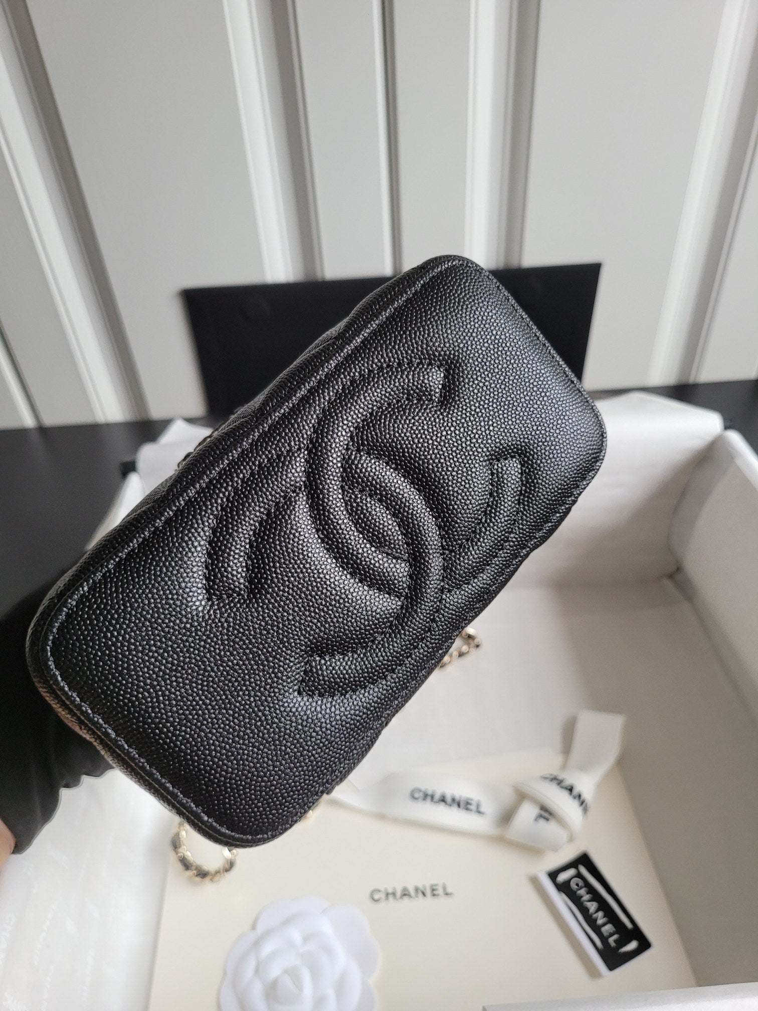 Chanel quilted mini handbag in dark color with embossed CC logo on front
