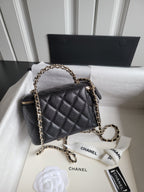 Chanel quilted crossbody bag with gold chain strap and front CC logo, top zip