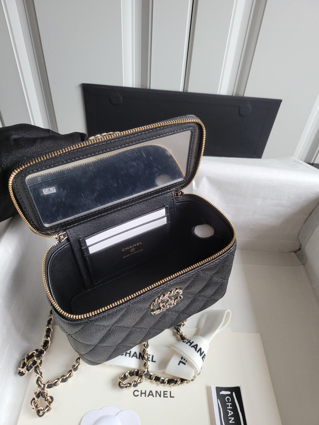 Chanel quilted crossbody bag with open top showing card slots, gold zipper trim