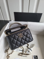 Chanel quilted shoulder bag with gold chain strap and front CC logo, top zip closeup
