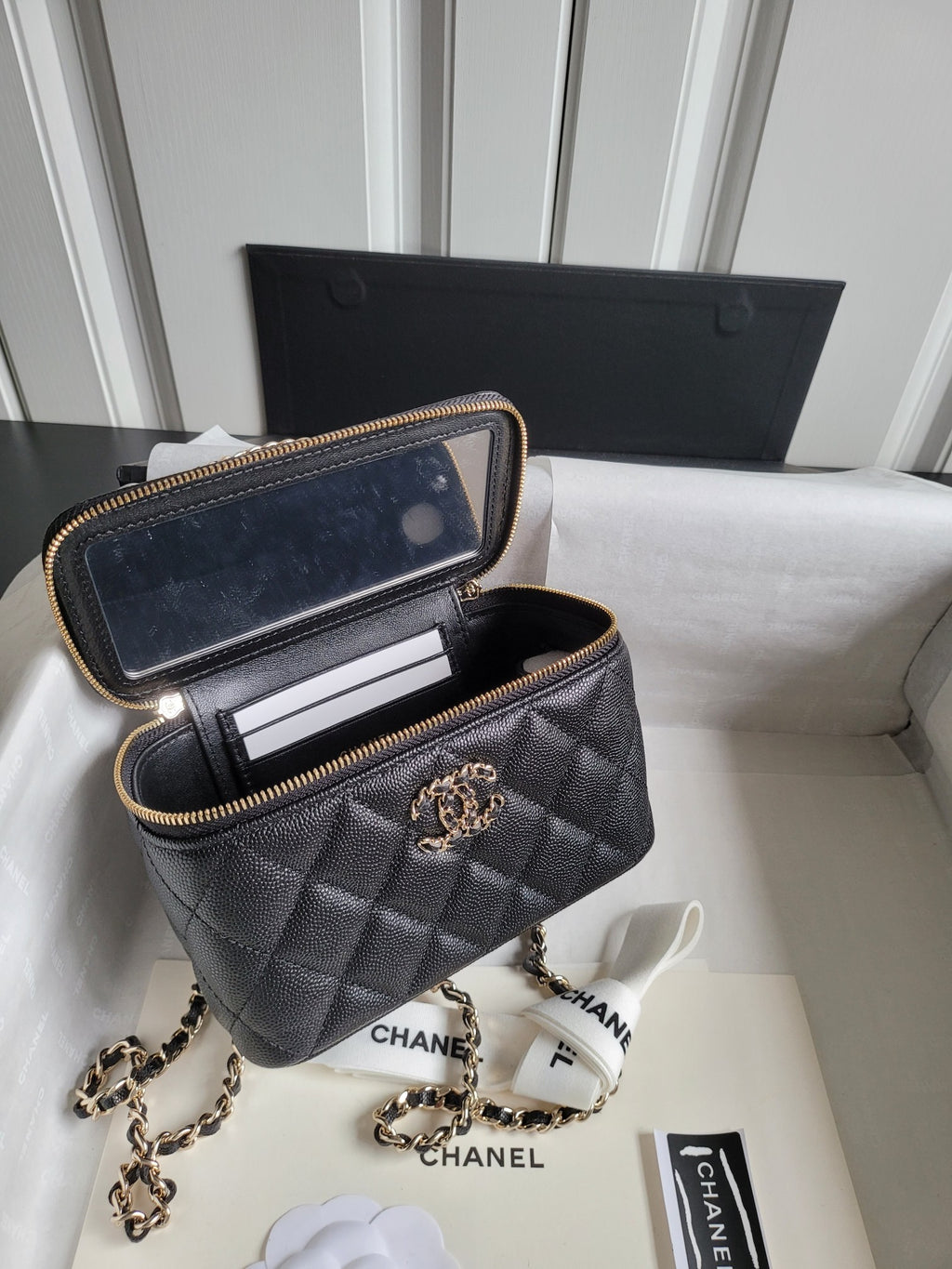 Chanel quilted mini bag with open interior, gold chain strap and front CC emblem