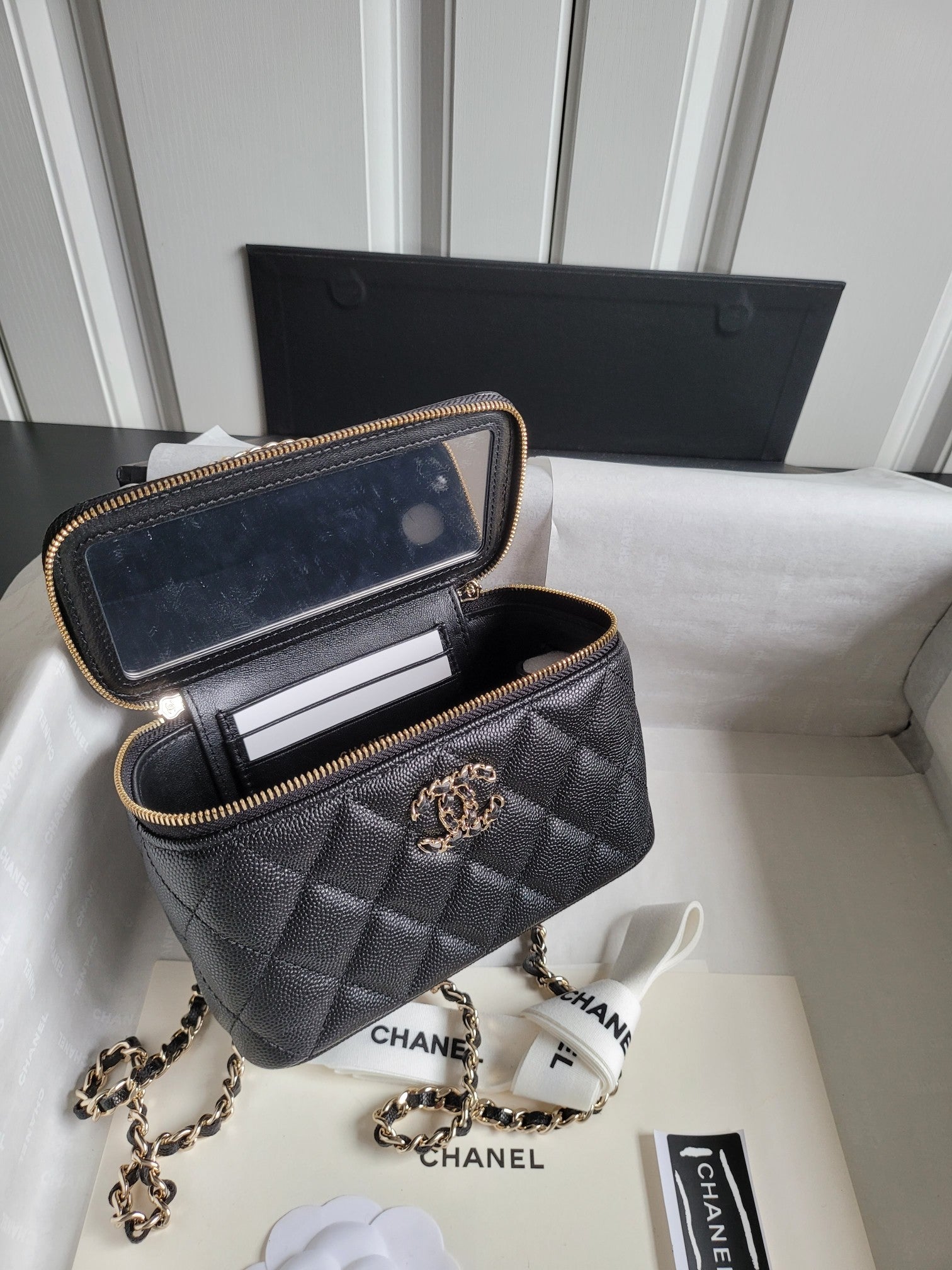 Chanel quilted mini bag with open interior, gold chain strap and front CC emblem