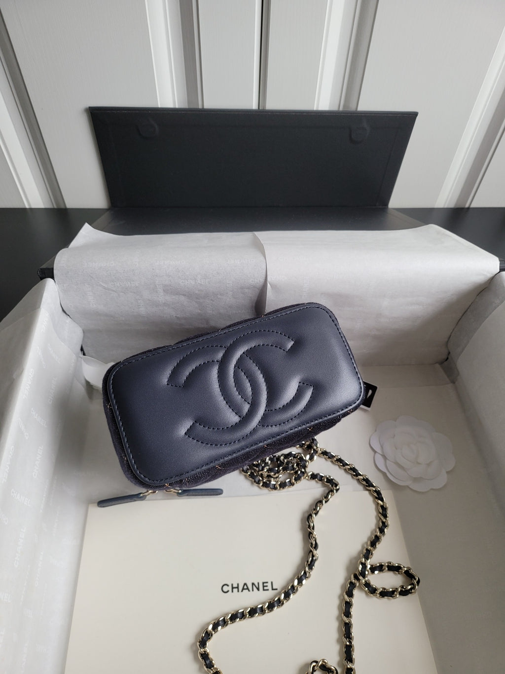 Chanel small shoulder bag with chain strap, dark navy logo and front flap closure
